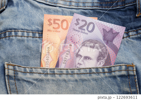 Barbadian dollar in the pocket of blue jeans Barbadian dollar in the pocket of blue jeans 122693611