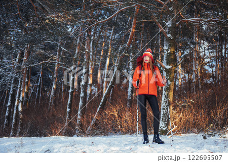 Woman Traveler with backpack hiking Travel Lifestyle adventure concept active vacations outdoor. Beautiful landscape forest Woman Traveler with backpack hiking Travel Lifestyle adventure concept active vacations outdoor. Beautiful landscape forest 122695507