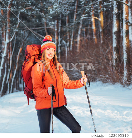 Woman Traveler with backpack hiking Travel Lifestyle adventure concept active vacations outdoor. Beautiful landscape forest Woman Traveler with backpack hiking Travel Lifestyle adventure concept active vacations outdoor. Beautiful landscape forest 122695519