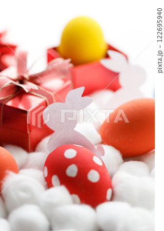 Happy Easter eggs and gift boxes on white background. Easter decoration. 122695940