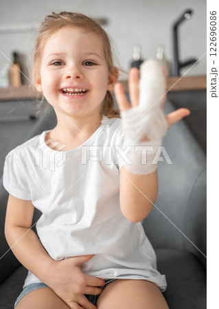 Little girl with broken finger at the doctor's appointment in the hospital Little girl with broken finger at the doctor's appointment in the hospital 122696086