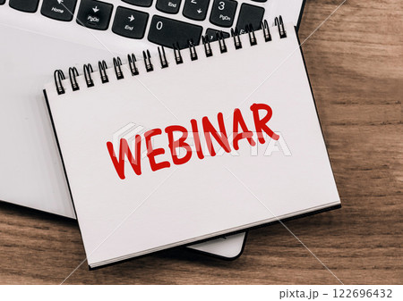 Webinar Text on note pad with computer keyboard 122696432