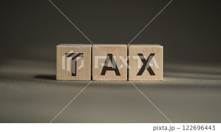 TAX text as symbol on cube wooden blocks. TAX text as symbol on cube wooden blocks. 122696443