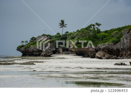 Landscape of the Indian Ocean coastline with at Mtende Beach, Zanzibar. Rocks and white sand. View from the sea 122696453