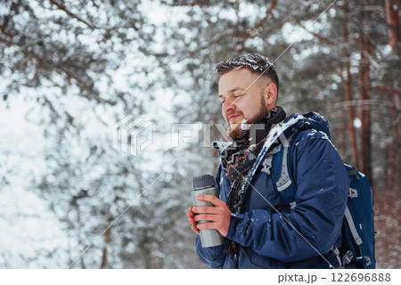 Man Traveler with backpack hiking Travel Lifestyle adventure concept active vacations outdoor. Beautiful landscape forest 122696888