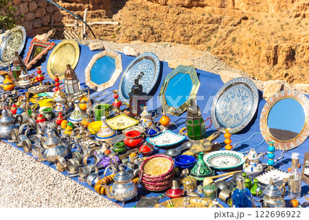 Multicolored Moroccan craft souvenirs at the market. Teapots and plates , decorations, tagines,, trinkets Multicolored Moroccan craft souvenirs at the market. Teapots and plates , decorations, tagines,, trinkets 122696922