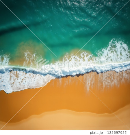 an impressive tropical beach with a view of the ocean waves from above, bright sunlight, yellow sand and blue frothy waves, beautiful nature as a backdrop 122697925