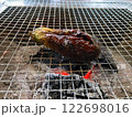 炭火の網の上で焼かれている茄子 122698016