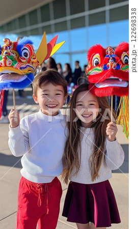 Asian children celebrating with colorful dragon heads at cultural festival 122698338
