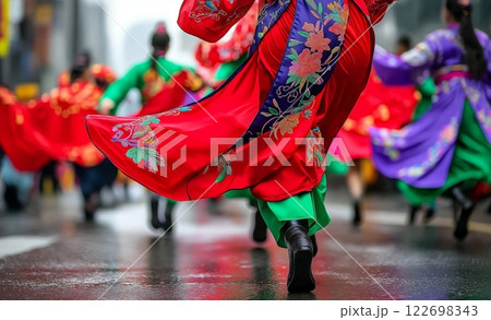 Colorful traditional dance with asian women in vibrant hanbok dresses on wet street 122698343