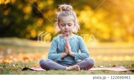 A young girl meditating outdoor 122698461