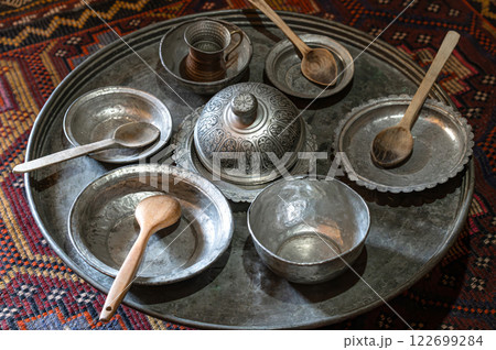Old Arabic copper tableware and utensils. Traditional turkish metal antique silver and copper pots, plates and vases Old Arabic copper tableware and utensils. Traditional turkish metal antique silver and copper pots, plates and vases 122699284