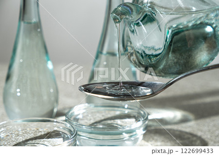 White distilled vinegar is poured into spoon White distilled vinegar is poured into spoon 122699433