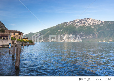 Lake Garda with mountains in background, view from Limone Sul Garda town, Italy, Europe. 122700238