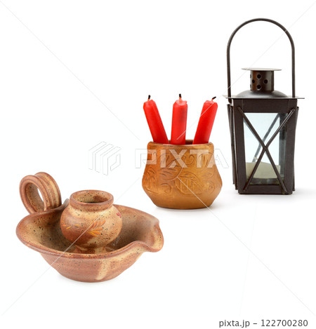 Clay candlestick, hand lantern and candle stubs isolated on white. Free space for text. Collage. 122700280