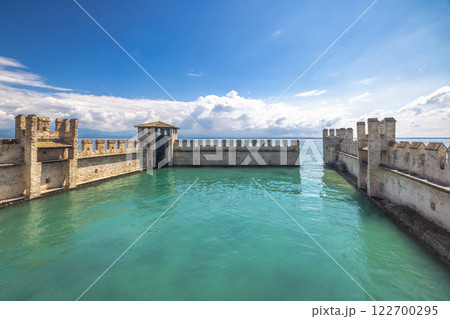 The walls of the Scaligero Castle on Lake Garda in historical centre of Sirmione, Italy, Europe. 122700295