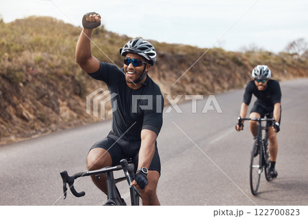 Winner, celebrating and winning cyclist cycling with his friend and racing outdoors in nature. Victory, joy and happy bicycle rider exercising on a bike for his workout routine on the road Winner, celebrating and winning cyclist cycling with his friend and racing outdoors in nature. Victory, joy and happy bicycle rider exercising on a bike for his workout routine on the road 122700823