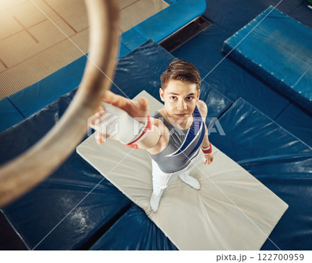 Sport, exercise and training ring for gymnastics exercise with a boy gymnast student in a gym. Top focus of an athlete about to do a fitness, wellness and sports workout to train for a performance 122700959