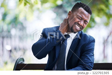 Stress, burnout or pain and a business man with an neck injury in the city. Corporate worker in need of medical aid or emergency care after an accident sitting on a bench, overworked with a headache 122701305