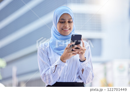 Islam, islamic or business woman on her phone in hijab texting in the city with mockup. Diversity, muslim and arabic international employee on mobile working in town or global corporate company. 122701449