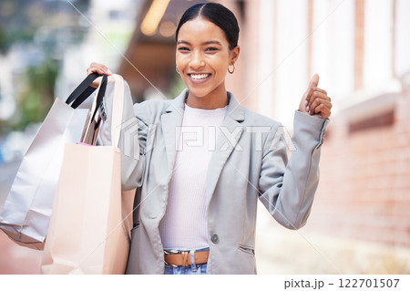 Shopping, retail and celebration of a young woman in the city, cheering, spending money and looking for a sale in the city. Enjoying a day at the shop, store or mall against an urban background 122701507
