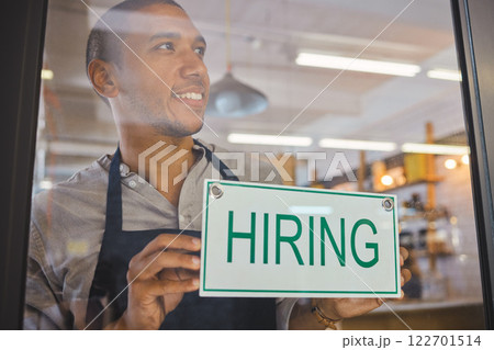 Recruitment, advertising and small business owner with hiring sign board on window or door of cafe or restaurant, happy and positive. Young business man excited open after end of covid virus pandemic 122701514