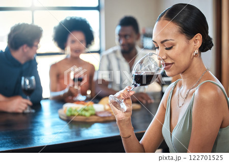 Woman with glass of luxury red wine or quality alcohol drinking in food, culinary or hospitality industry. People wine tasting experience of fruit scent drink with friends in a restaurant background 122701525
