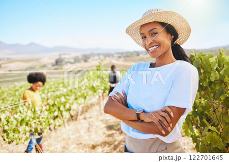Confident or proud farmer with arms crossed and smile vineyard agriculture field. Young woman on sustainable wine or green fruit farm in summer. Worker happy with growth sustainability on countryside 122701645