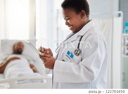 Healthcare, insurance and doctor reading good test results or an exciting email on a digital tablet and feeling positive. Medical worker smiling due news of cure or treatment for her sick patient Healthcare, insurance and doctor reading good test results or an exciting email on a digital tablet and feeling positive. Medical worker smiling due news of cure or treatment for her sick patient 122701650