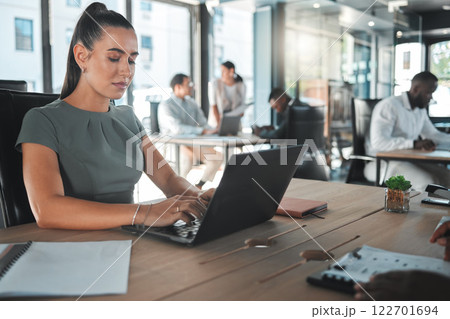 Business woman on a computer at a startup company, working on email. Girl in corporate management at a desk on the internet in tech office or a web designer learning to design a website on a laptop. Business woman on a computer at a startup company, working on email. Girl in corporate management at a desk on the internet in tech office or a web designer learning to design a website on a laptop. 122701694