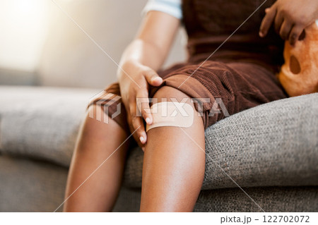 Child with plaster or bandaid, injured and hurt by accident while playing a sport, exercise or outside closeup. Kid with a medical bandage after help on wound, injury or scratch on skin, knee or leg Child with plaster or bandaid, injured and hurt by accident while playing a sport, exercise or outside closeup. Kid with a medical bandage after help on wound, injury or scratch on skin, knee or leg 122702072
