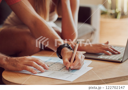 Couple calculating budget, finance and tax while planning investment, loan and bills on writing paper and laptop at home. Managing household spending, savings and insurance report for online banking Couple calculating budget, finance and tax while planning investment, loan and bills on writing paper and laptop at home. Managing household spending, savings and insurance report for online banking 122702147