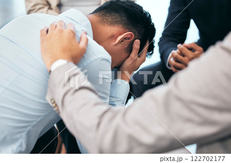 Support and empathy for suffering from mental health, .anxiety and depression businessman in group therapy. Love, care and trust from friends or coworkers for sad man in stress and pain from bad news 122702177