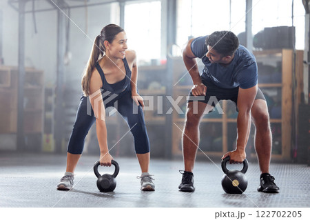 Strong, wellness couple doing kettlebell weight exercise, workout or training inside a gym. Happy sports people or trainer motivation, exercising with fitness equipment for muscle, strength or health Strong, wellness couple doing kettlebell weight exercise, workout or training inside a gym. Happy sports people or trainer motivation, exercising with fitness equipment for muscle, strength or health 122702205