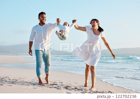 Beach, swing and parents with girl for holding hands, travel holiday and bonding together outdoor. Playful, mom and dad with child for family game, walking and happy for vacation experience by ocean Beach, swing and parents with girl for holding hands, travel holiday and bonding together outdoor. Playful, mom and dad with child for family game, walking and happy for vacation experience by ocean 122702236