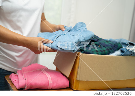 Donation box with used clothes at home to support help for poor people in the world. 122702526