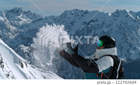 Skier throwing snow in the Italian Dolomites during sunny day , Alpine scenery 122702684