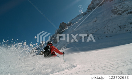 Skier riding in the scenic Alps mountains in fresh powder snow , beautiful sunny day Skier riding in the scenic Alps mountains in fresh powder snow , beautiful sunny day 122702688