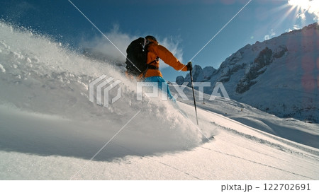 Skier riding in the scenic Alps mountains in fresh powder snow , beautiful sunny day Skier riding in the scenic Alps mountains in fresh powder snow , beautiful sunny day 122702691