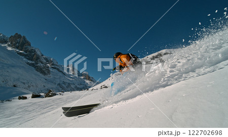 Skier riding in the scenic Alps mountains in fresh powder snow , beautiful sunny day Skier riding in the scenic Alps mountains in fresh powder snow , beautiful sunny day 122702698