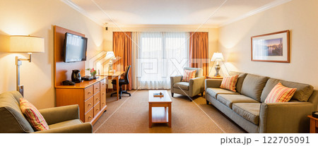 Cozy and inviting hotel suite with modern amenities and large windows 122705091