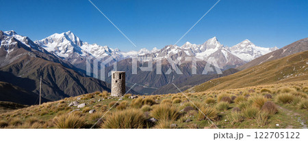 Majestic mountain landscape with an ancient stone tower under a clear blue sky in the Andes region 122705122
