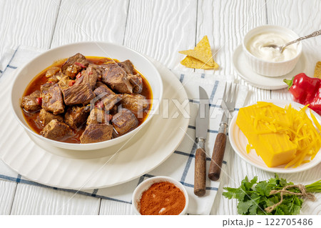 beef stew in a white bowl on rustic wooden table beef stew in a white bowl on rustic wooden table 122705486