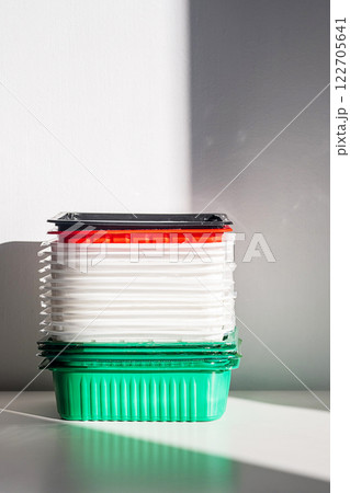 Pile of disposable plastic food containers ready for sorting and recycling. 122705641