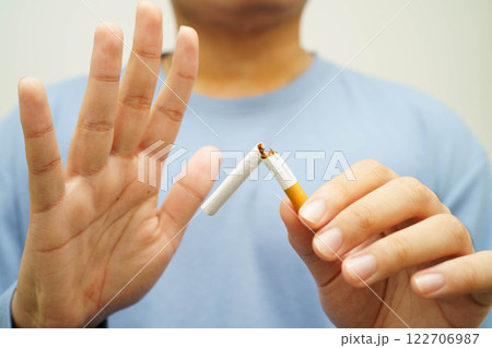 Quit smoking, Asian man breaking destroy cigarette in hand. 122706987