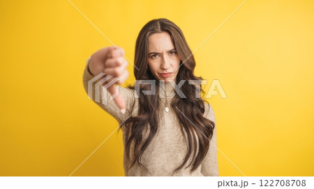Woman expressing disapproval with thumbs down gesture 122708708