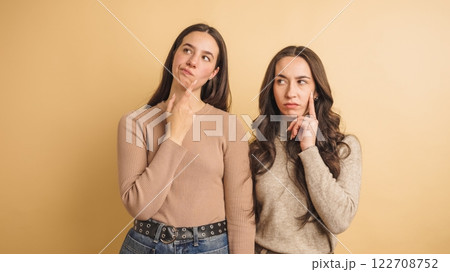 Two thoughtful women contemplating ideas together 122708752
