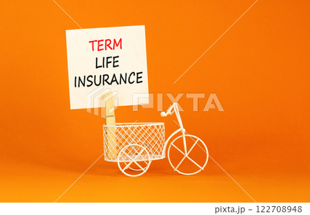 Term life insurance symbol. Concept words Term life insurance on beautiful white paper on clothespin. Beautiful orange background. Miniature bicycle. Business term life insurance concept. Copy space. 122708948