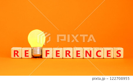 References symbol. Concept word References on beautiful wooden blocks. Beautiful orange table orange background. Yellow light bulb. Business references reference concept. Copy space. 122708955
