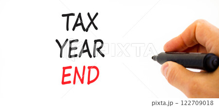 Tax year end symbol. Concept words Tax year end on beautiful white paper. Beautiful white background. Businessman hand. Business tax year end concept. Copy space. 122709018